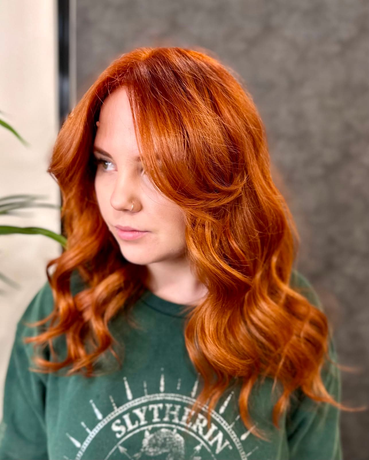 Client with glossy copper red waves and curtain fringe