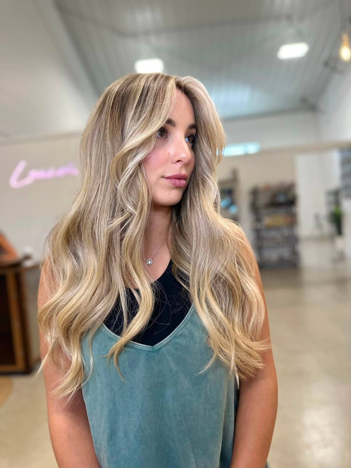 Client with long, soft blonde balayage and face-framing pieces