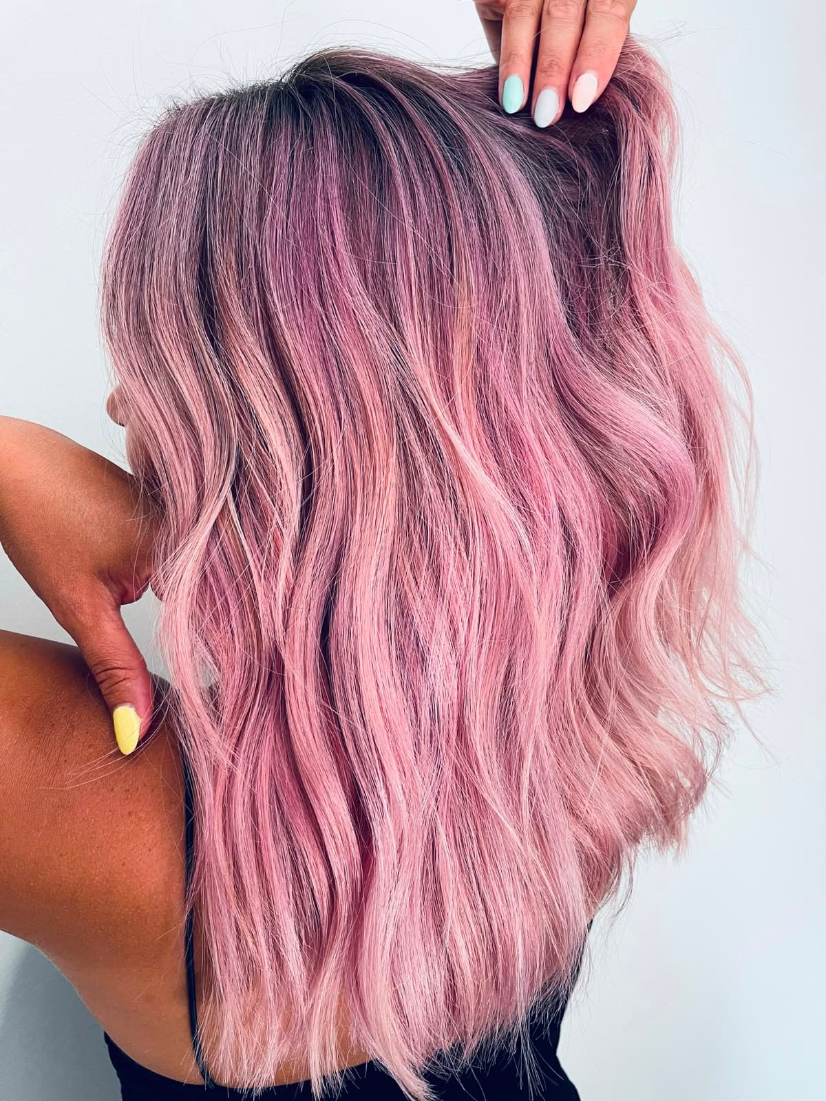 Back view of soft waves coloured a pastel rose pink with a shadowed root